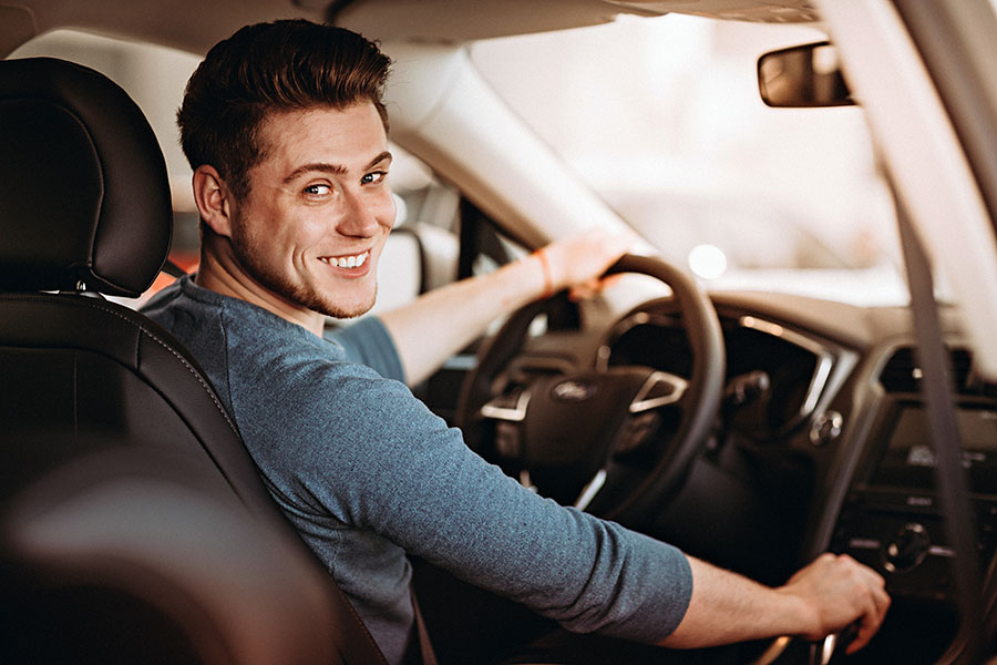 Add or Remove Driver - Man Driver Turning Around and Smiling in Drivers Seat